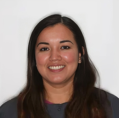 Professional headshot of a smiling woman with long dark hair against a white background.
