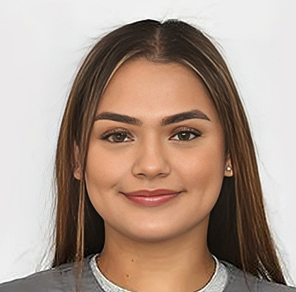 Young woman smiling at camera in professional headshot against white background.