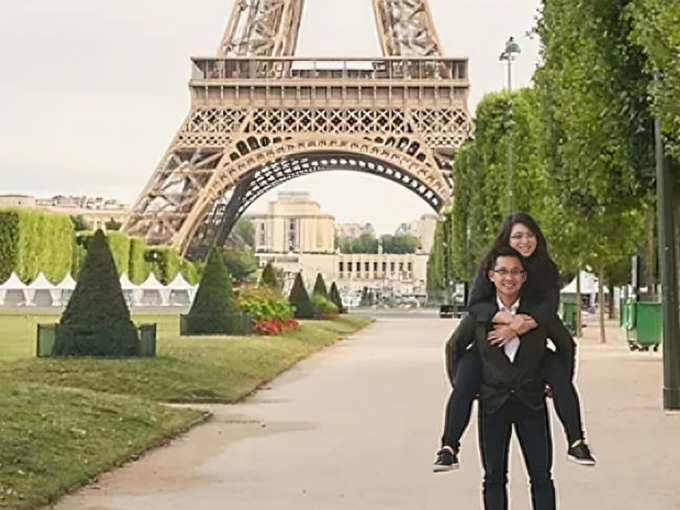 Two people posing together in front of the Eiffel Tower in Paris.
