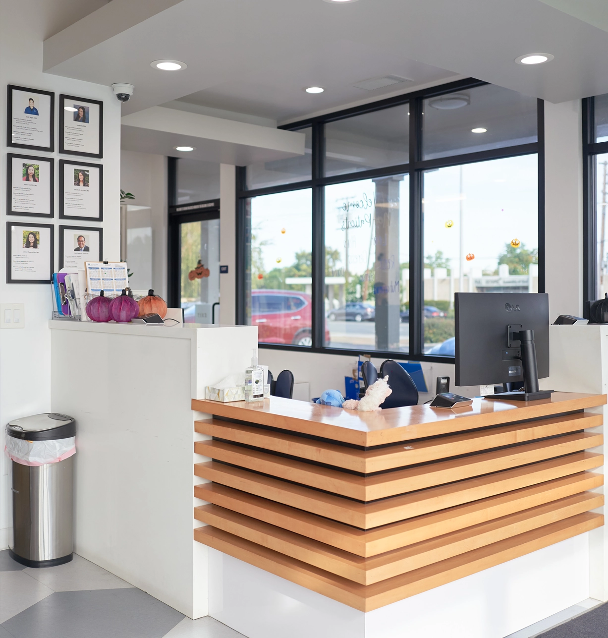 Modern pediatric dental office reception area with wooden desk and contemporary design elements.